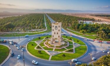 Burj An Nahdah Roundabout in Salalah with the iconic white tower and green surroundings