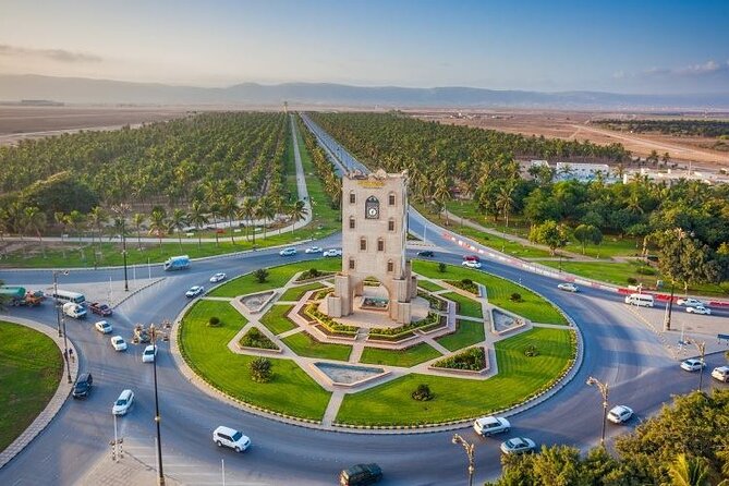 Burj An Nahdah Roundabout in Salalah with the iconic white tower and green surroundings