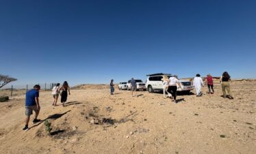 Tourists on sand dunes Salalah