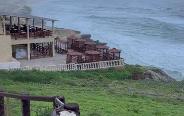 Waves crashing through natural blowholes at Mughsail Beach in Salalah