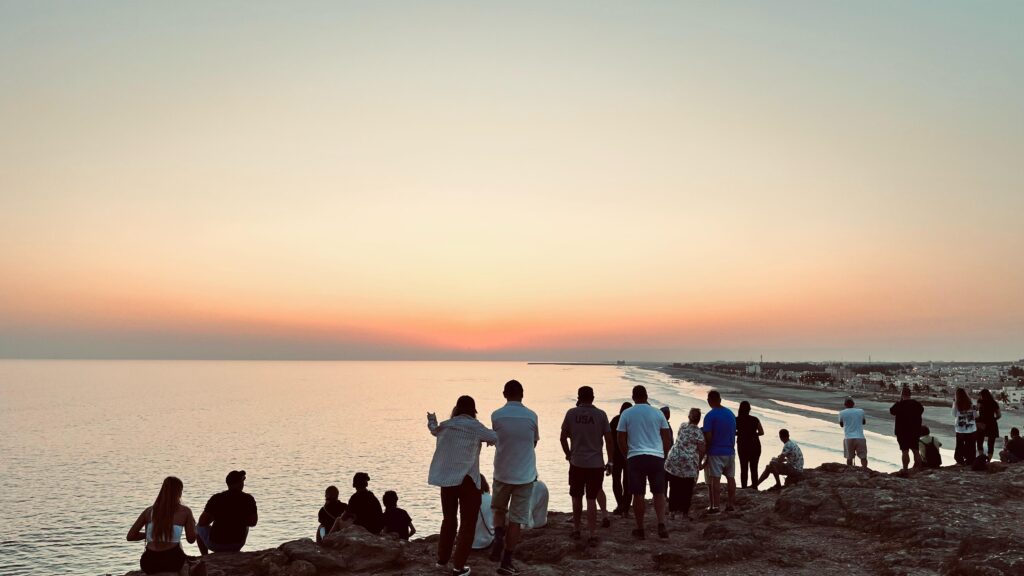 Tour group with guide witnessing the sunset at Taqah Viewpoint