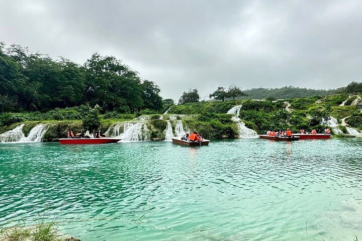 Boats floating on Wadi Darbat Lake