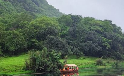 Wadi Darbat lake reflecting the surrounding green hills