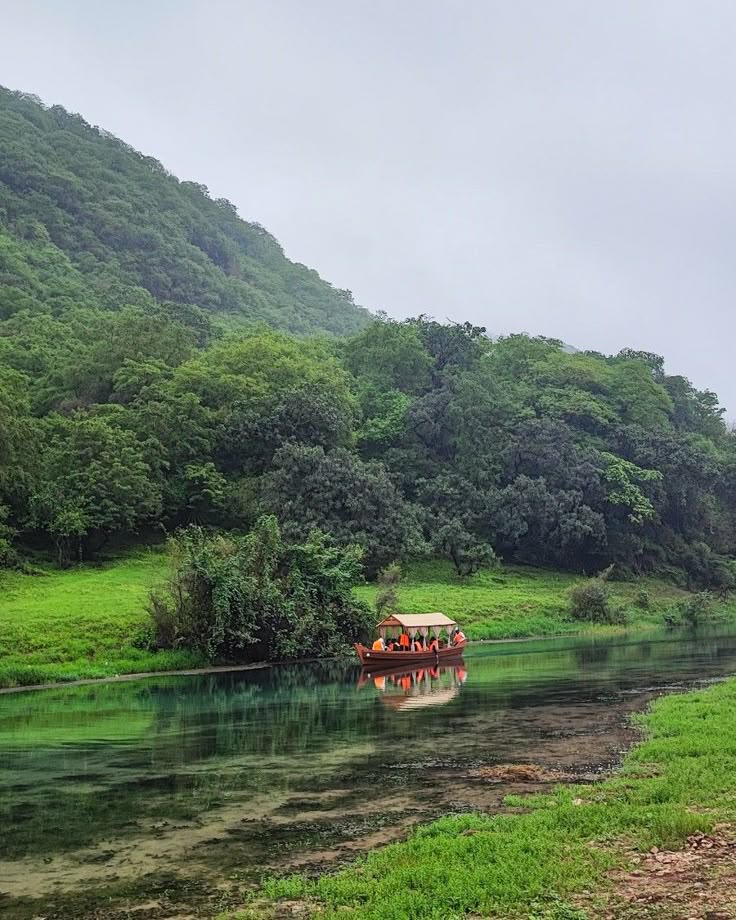 Wadi Darbat lake reflecting the surrounding green hills