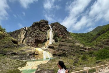 Travelers walking near waterfalls at Wadi Darbat, East Salalah private tour