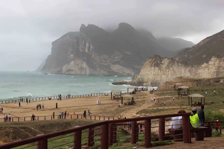 Visitors walking along the wooden path at Mughsail Blowholes