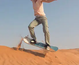 Sandboarding during Salalah Desert Safari
