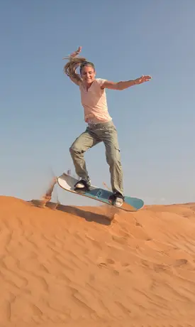 Sandboarding during Salalah Desert Safari