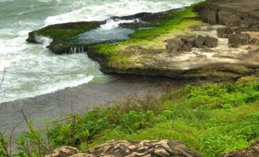 Rocky cliffs and natural pools at Mughsail Beach in Salalah