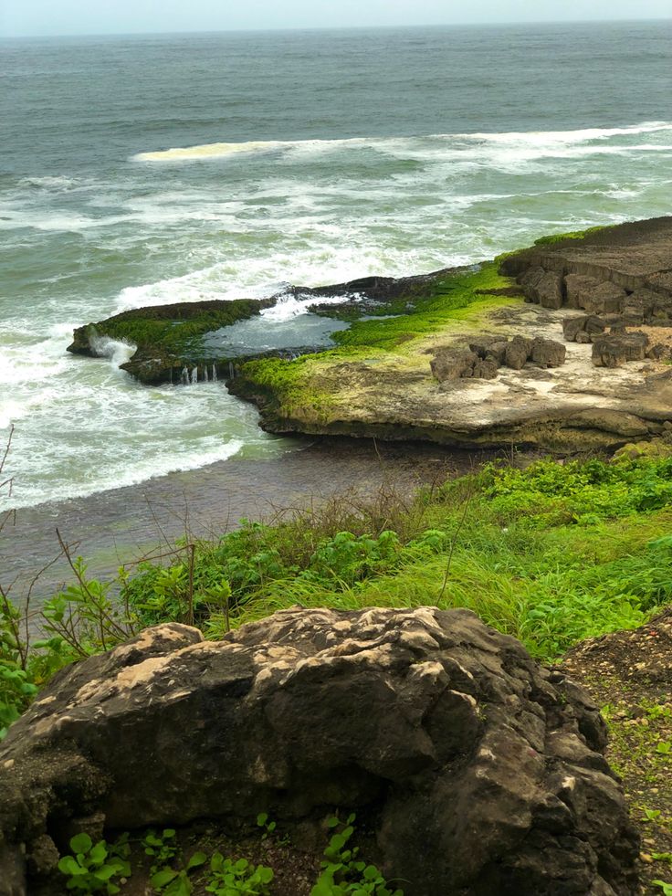 Rocky cliffs and natural pools at Mughsail Beach in Salalah