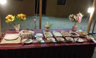 traditional Omani dinner served in Empty Quarter desert camp